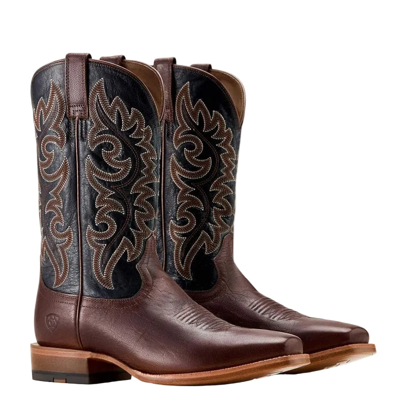 Pair of brown cowboy boot with a black upper shaft and intricate brown stitching on a white background